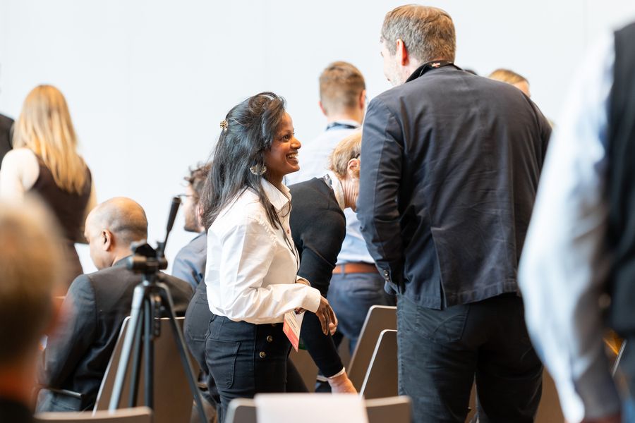 An attendee smiling mid-conversation