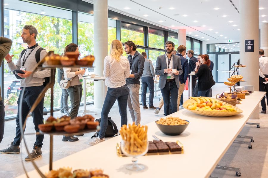 Attendees mingling over coffee and pastries